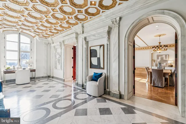 a living room with fireplace furniture and a chandelier