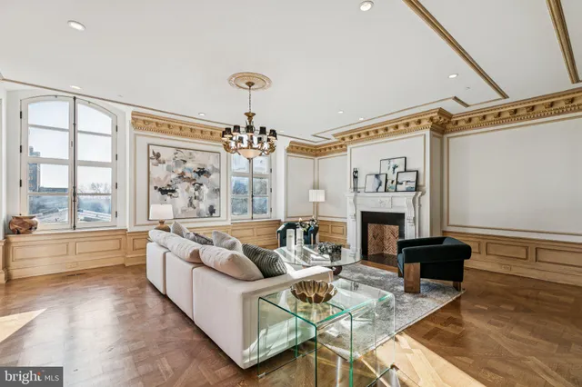 a living room with fireplace furniture and a large window