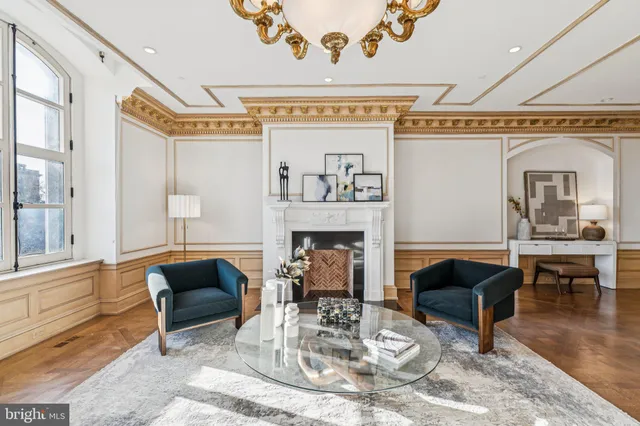 a living room with furniture and a chandelier