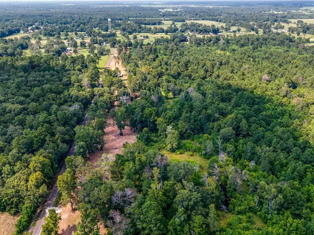 an aerial view of a houses with a yard