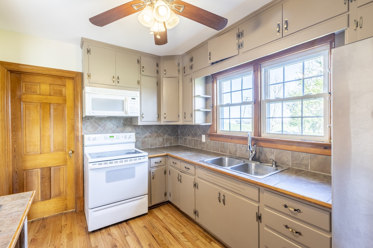 713 Battlefield Road Fort Defiance, VA 24437 - Photo 35 of 47 a kitchen with a sink cabinets stainless steel appliances and a window