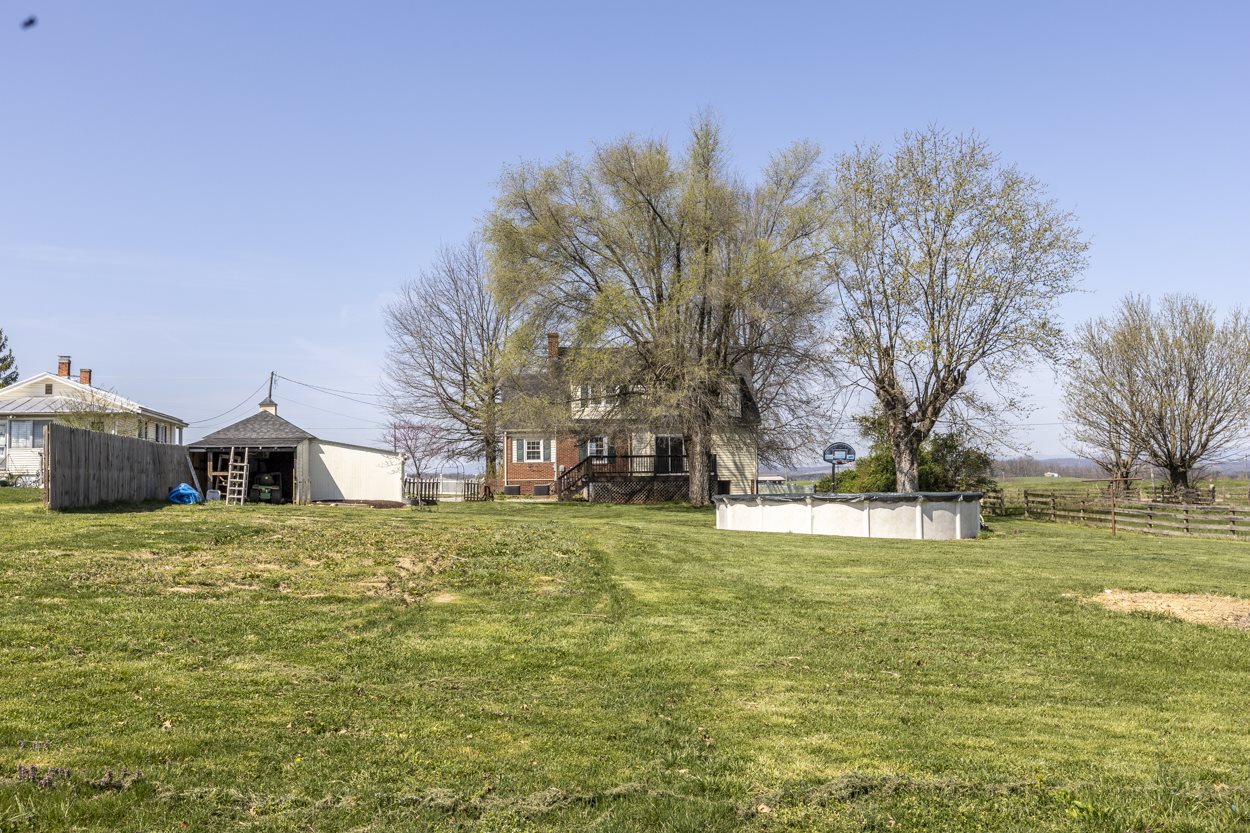 713 Battlefield Road Fort Defiance, VA 24437 - Photo 10 of 47 a large white house with a big yard and large trees