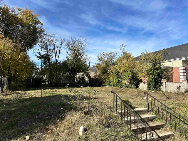 a view of a pathway with a wrought fence