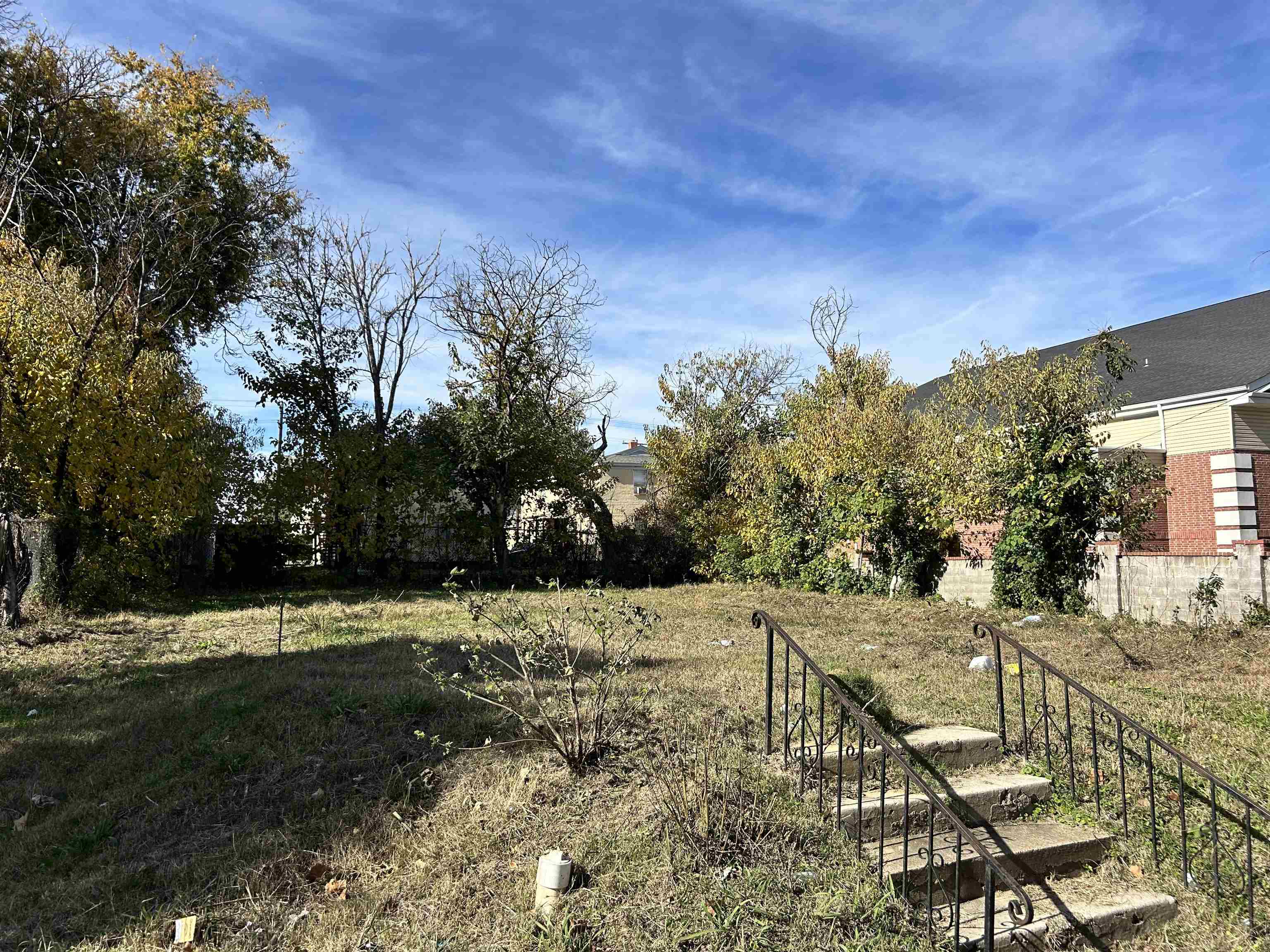 a view of a pathway with a wrought fence