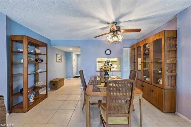 a view of a dining room with furniture and a chandelier