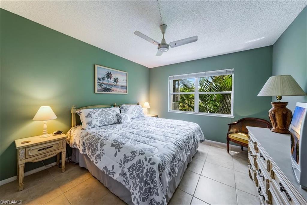 3 Bluebill Avenue, Unit 207 Naples, FL 34108 - Photo 19 of 32 a bedroom with a bed and a window