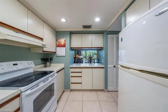 a kitchen with cabinets appliances a sink and a counter top space