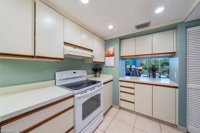 a front view of multi story residential apartment building with yard and green space