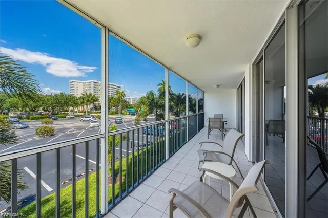 a living room with furniture a flat screen tv and a floor to ceiling window