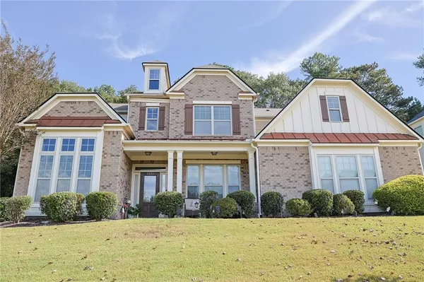 a front view of a house with a yard