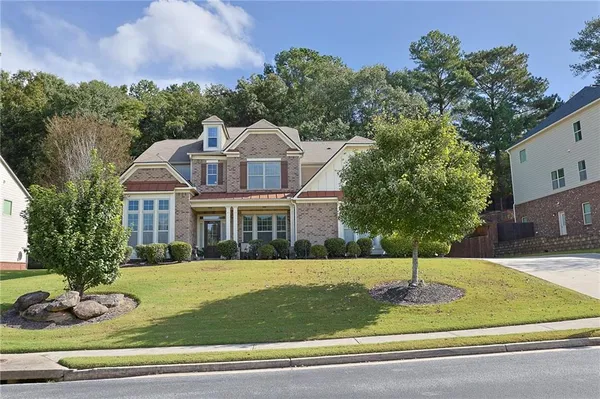 a front view of a house with a yard