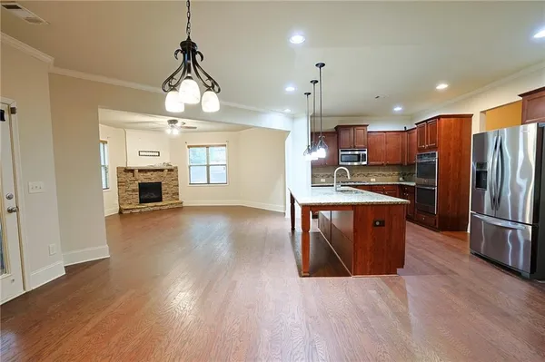 an empty room with windows and fireplace