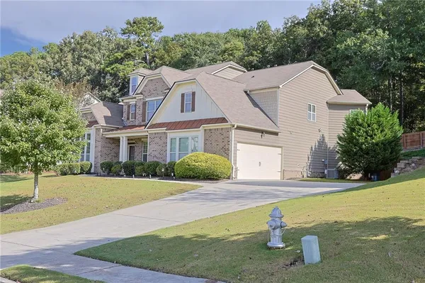a front view of a house with yard