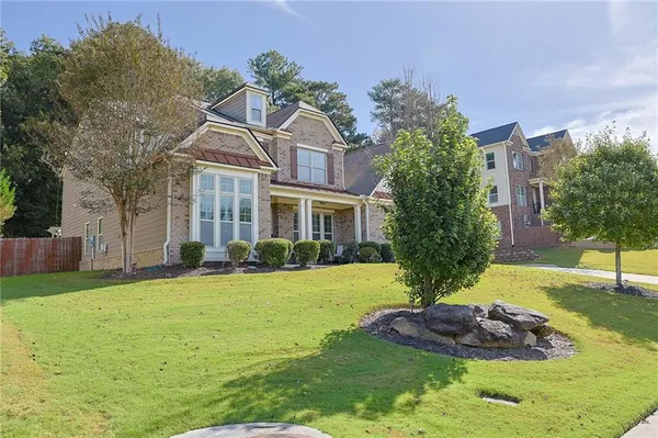 a view of a brick house with large windows and a large window