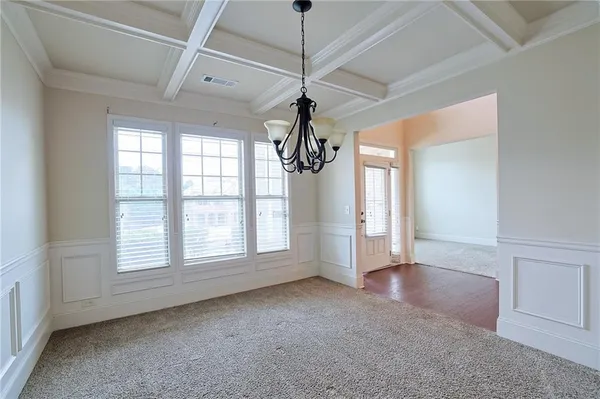 a view of a livingroom with a ceiling fan window and wooden floor