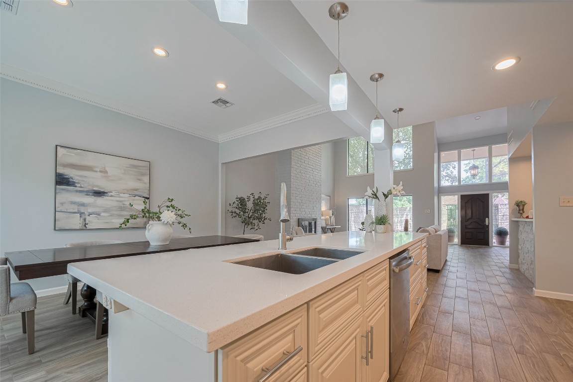 15600 Barkers Landing Road, Unit 20 Houston, TX 77079 - Photo 11 of 49 A huge island connects the gourmet kitchen with the dining room. Same light color quartz in all kitchen countertops.