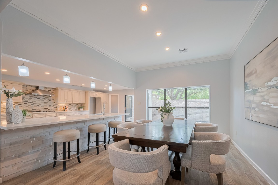 15600 Barkers Landing Road, Unit 20 Houston, TX 77079 - Photo 18 of 49 This view shows the formal dining area where you can fit a very large table that can accommodate 10-12 people easily or more:) Notice how big is the island with space to accommodate even more people sitting at the breakfast bar.