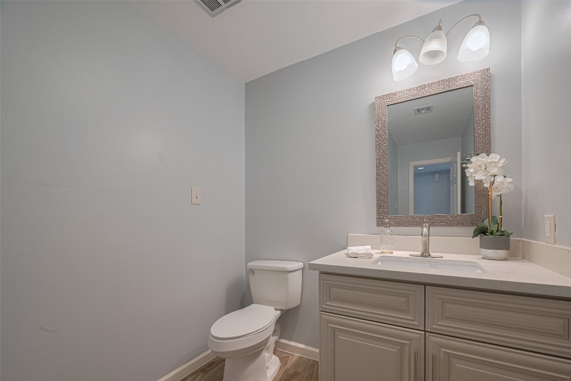 15600 Barkers Landing Road, Unit 20 Houston, TX 77079 - Photo 25 of 49 This is the spacious guest bathroom with light blue walls, featuring a sleek vanity with a large mirror and overhead lighting.