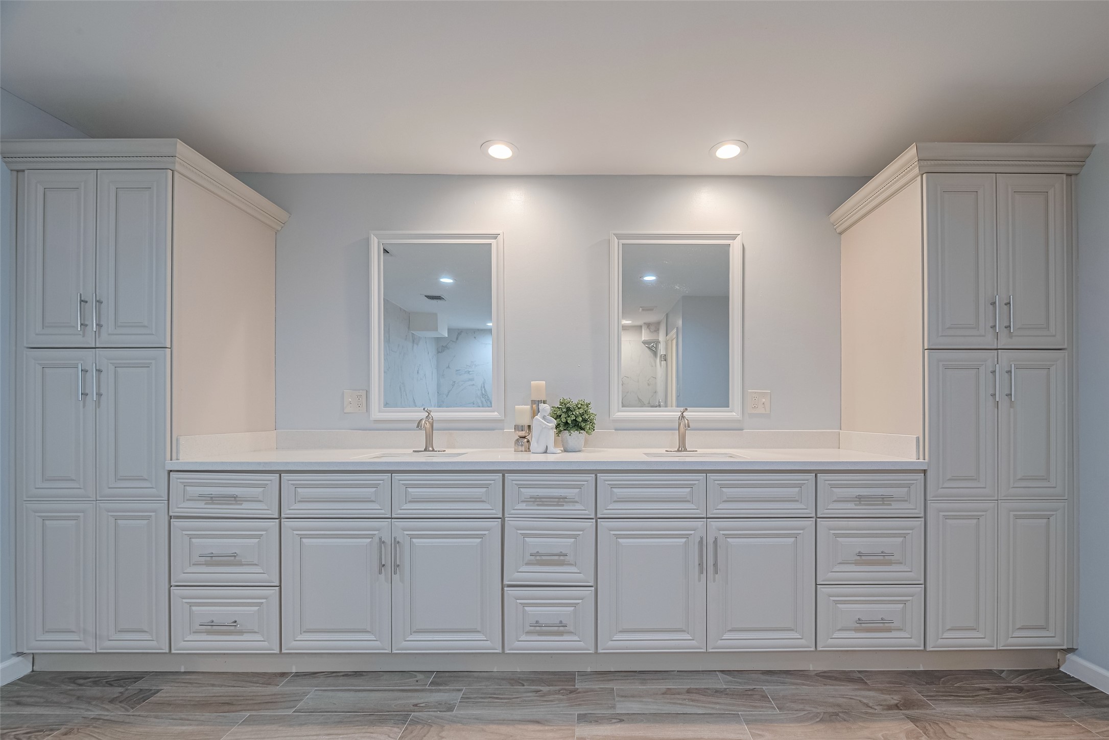 15600 Barkers Landing Road, Unit 20 Houston, TX 77079 - Photo 32 of 49 Notice the ample cabinet storage, sleek quartz countertops, and modern fixtures. It has two large mirrors and recessed lighting, creating a bright and spacious feel.