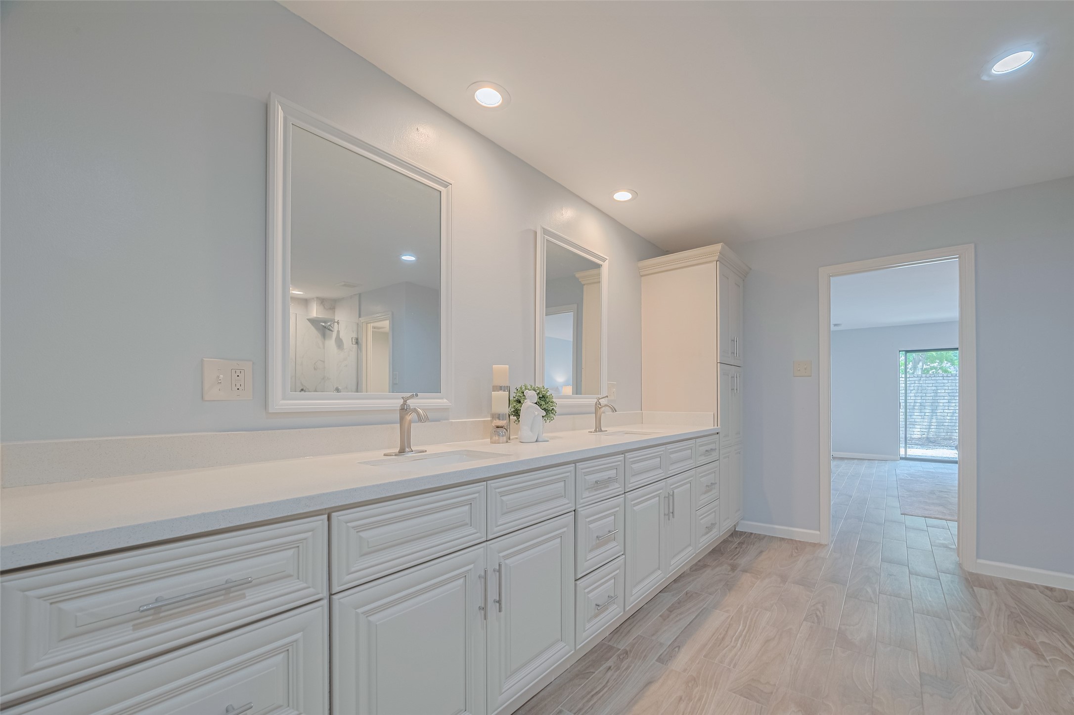 15600 Barkers Landing Road, Unit 20 Houston, TX 77079 - Photo 33 of 49 Another view of the long double vanity and the view to the Primary Bedroom and patio door.