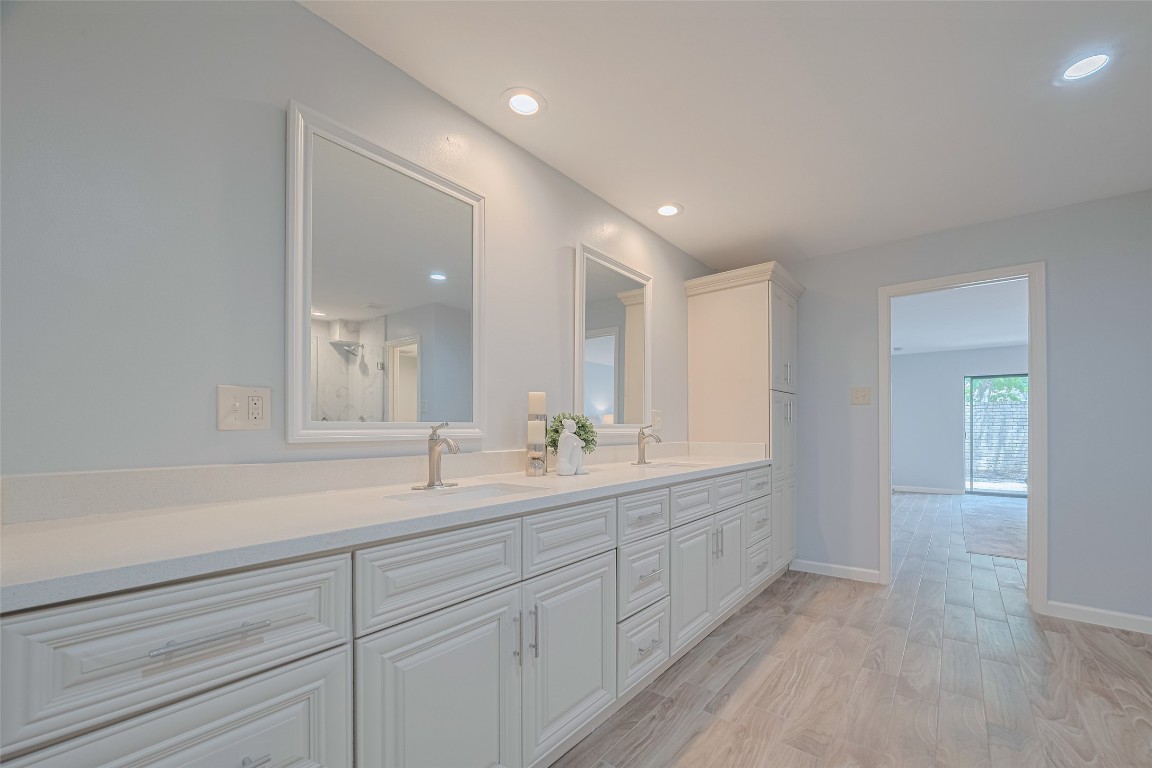 15600 Barkers Landing Road, Unit 20 Houston, TX 77079 - Photo 33 of 49 Another view of the long double vanity and the view to the Primary Bedroom and patio door.