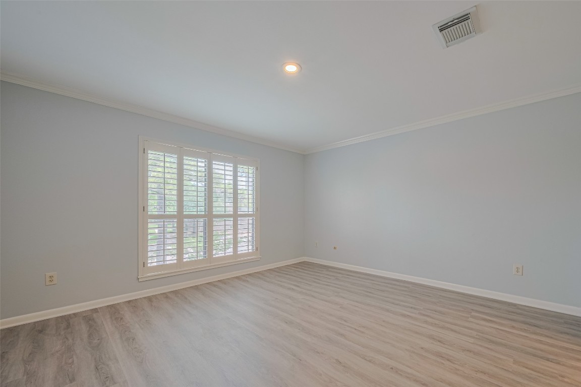 15600 Barkers Landing Road, Unit 20 Houston, TX 77079 - Photo 39 of 49 This is the first ensuite bedroom as soon as you climb the stairs with a large window with white plantation shutters provides natural light. It's accented with crown molding.