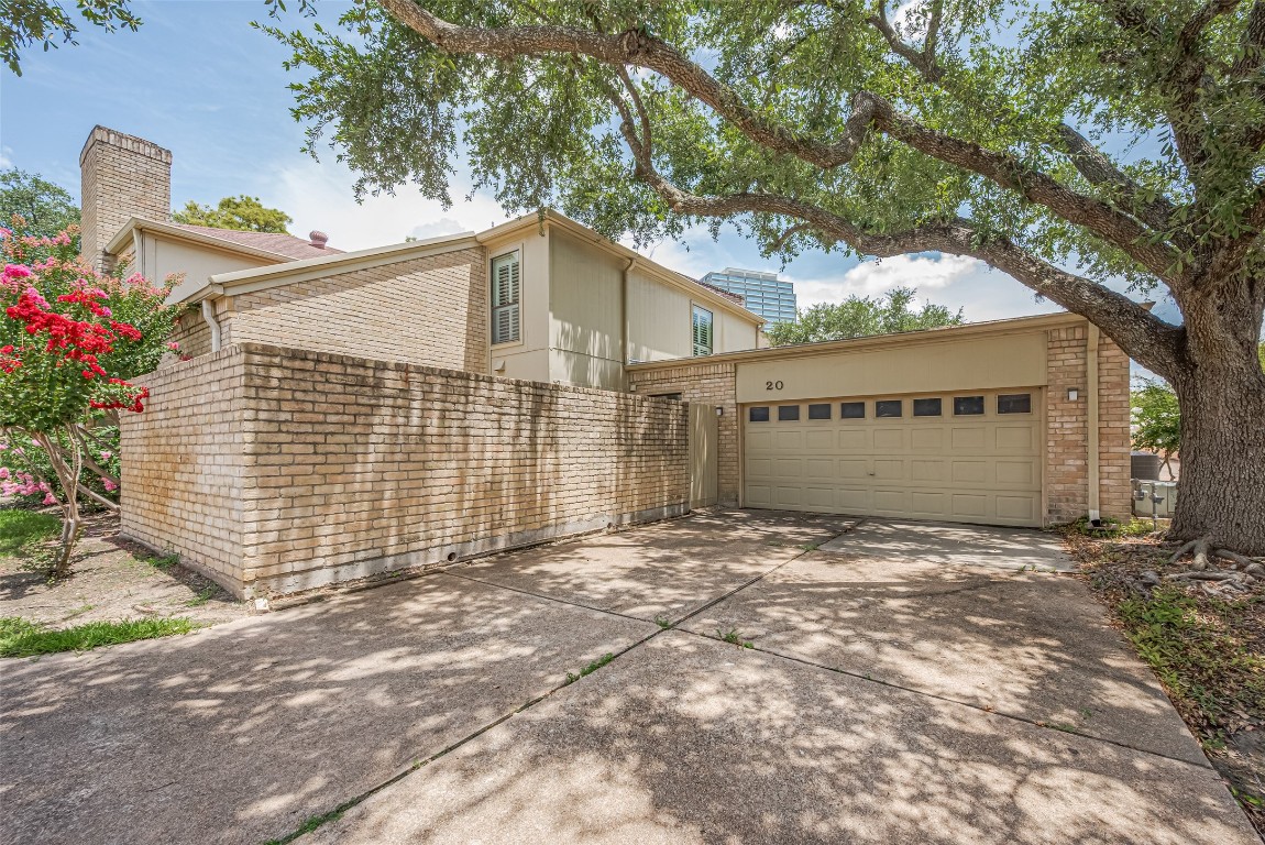15600 Barkers Landing Road, Unit 20 Houston, TX 77079 - Photo 48 of 49 This charming home features a two-car garage with a brick exterior and double wide driveway for extra parking. The property is situated on a corner.