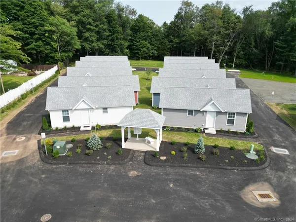 an aerial view of a house with garden space and street view