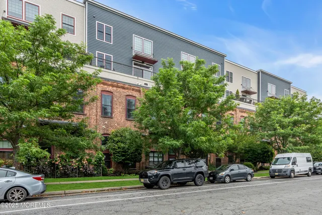 a car parked in front of a house with a parked car