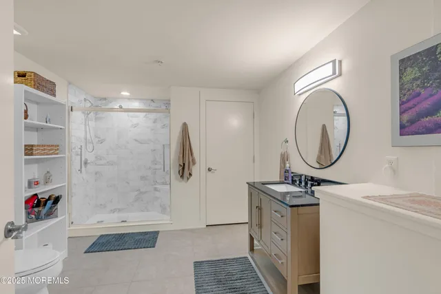 a bathroom with a sink a toilet and shower