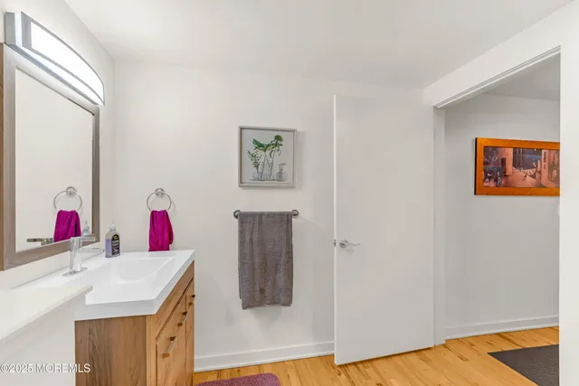 a bathroom with a sink vanity and a mirror