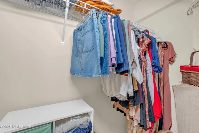 a view of walk in closet with clothes