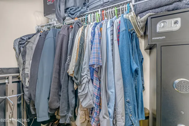 a view of walk in closet with clothes and shoes