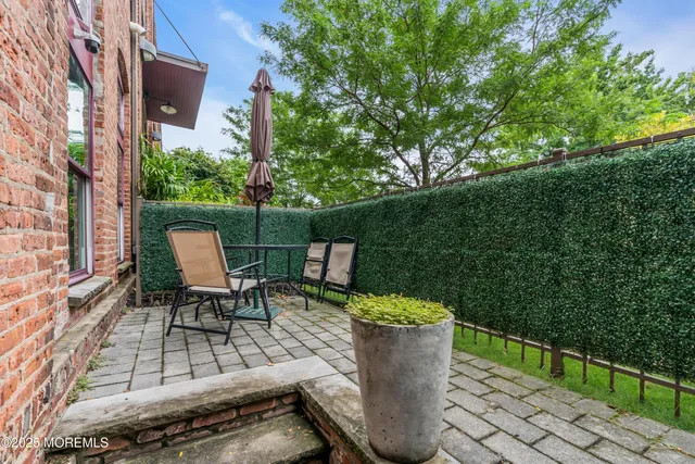 a view of a patio with table and chairs and potted plants