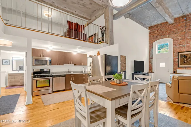 a kitchen with a table chairs stove and cabinets