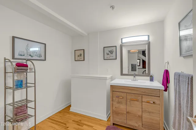 a bathroom with a sink vanity and mirror