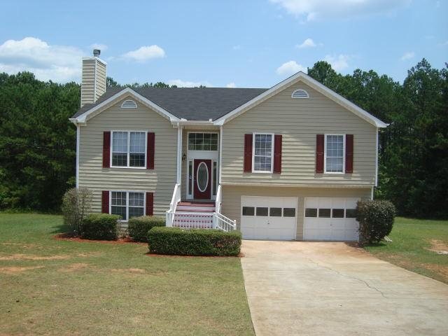 200 Cedar Ridge Lane Locust Grove, GA 30248 - Photo 1 of 1 a front view of a house with a yard