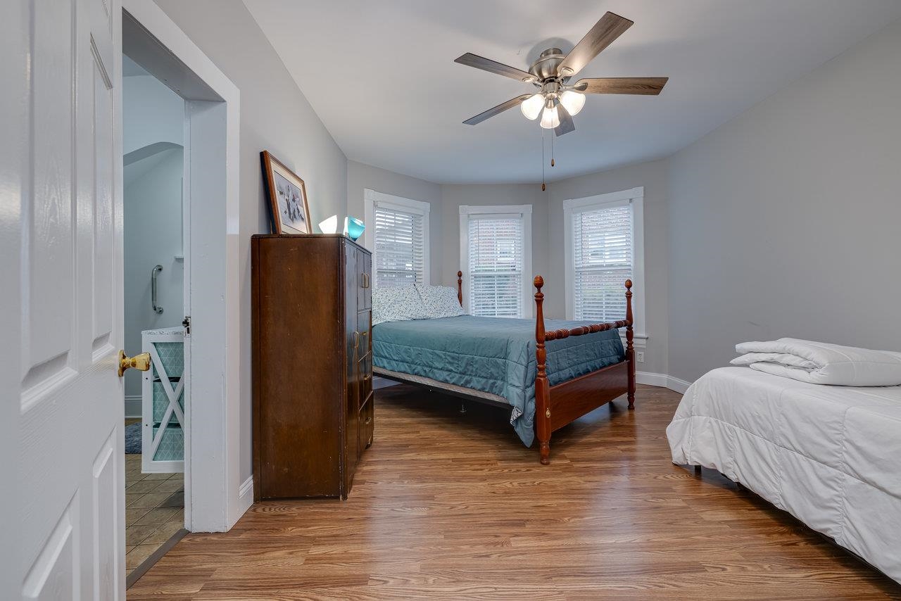 155 Main Street Dayton, VA 22821 - Photo 27 of 75 a bedroom with a bed and a chandelier