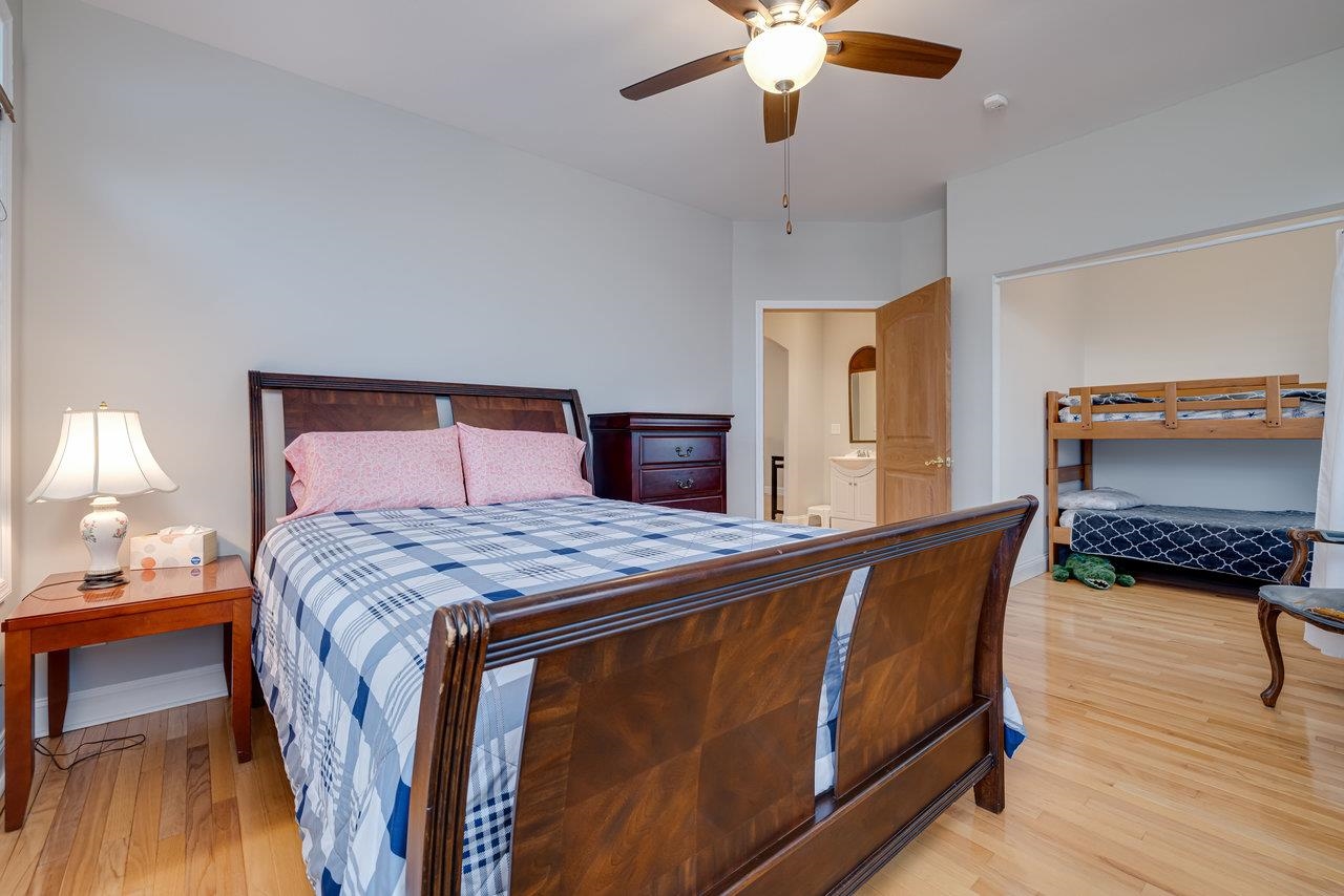 155 Main Street Dayton, VA 22821 - Photo 36 of 75 a bedroom with a bed and a chandelier