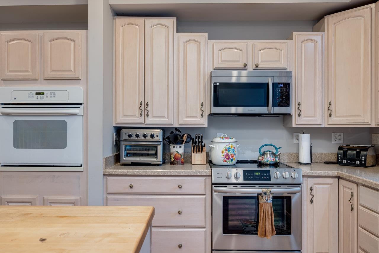 155 Main Street Dayton, VA 22821 - Photo 6 of 75 a kitchen with stainless steel appliances granite countertop white cabinets and a stove a oven with white countertops