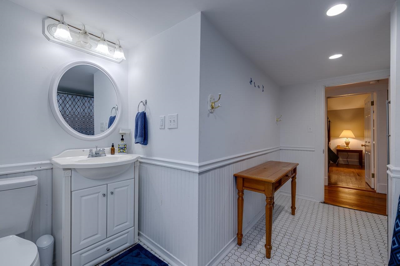 155 Main Street Dayton, VA 22821 - Photo 67 of 75 a bathroom with a toilet a sink and mirror