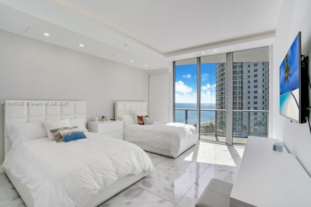 17475 Collins Avenue, Unit 602 Sunny Isles Beach, FL 33160 - Photo 13 of 24 a spacious bedroom with two large bed and a large window