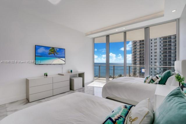 17475 Collins Avenue, Unit 602 Sunny Isles Beach, FL 33160 - Photo 14 of 24 a bedroom with a large bed and a large window