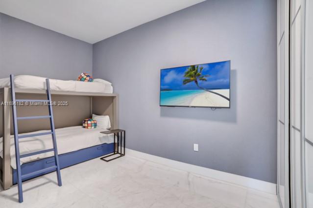 17475 Collins Avenue, Unit 602 Sunny Isles Beach, FL 33160 - Photo 15 of 24 a bedroom with a bed and a painting on the wall