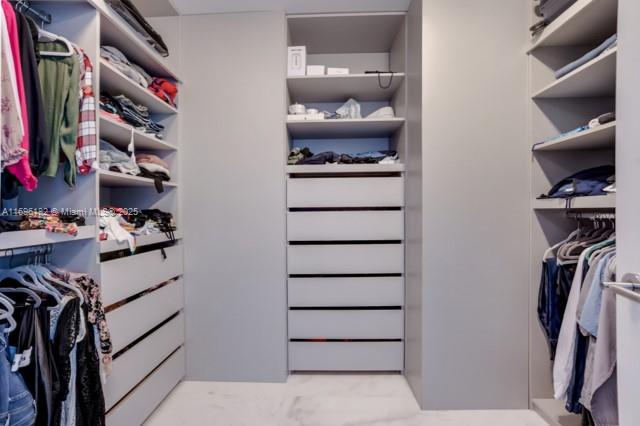 17475 Collins Avenue, Unit 602 Sunny Isles Beach, FL 33160 - Photo 17 of 24 a view of walk in closet with clothes and shoes