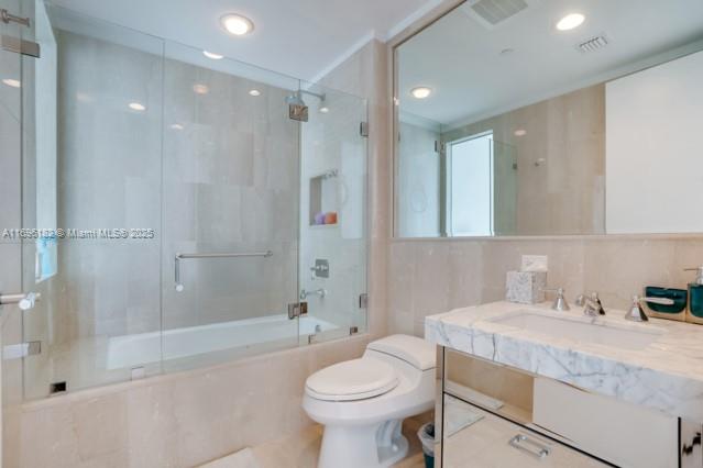 17475 Collins Avenue, Unit 602 Sunny Isles Beach, FL 33160 - Photo 20 of 24 a bathroom with a granite countertop sink toilet and shower