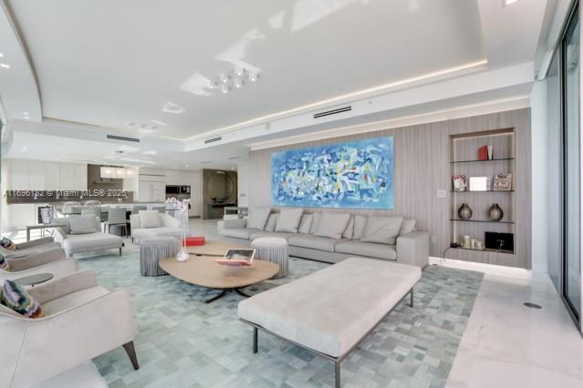 17475 Collins Avenue, Unit 602 Sunny Isles Beach, FL 33160 - Photo 4 of 24 a living room with furniture and a rug