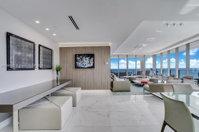 17475 Collins Avenue, Unit 602 Sunny Isles Beach, FL 33160 - Photo 7 of 24 a living room with furniture and a large window