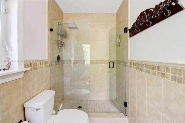 a bathroom with a toilet and shower