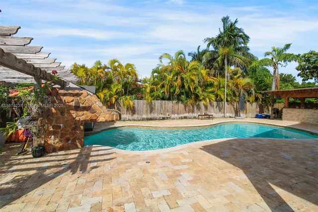 a picture of a bench in front of a wall